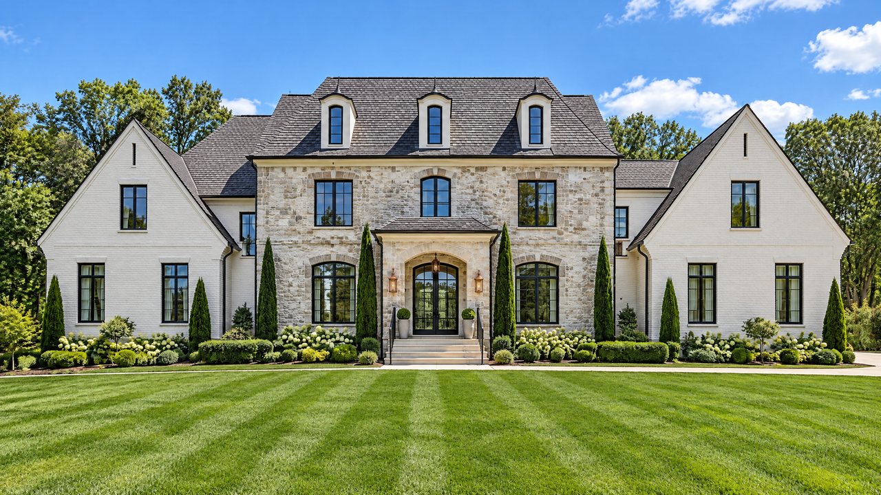 Concept rendering of a stone and white-brick estate home with a striped lawn (illustrative only)