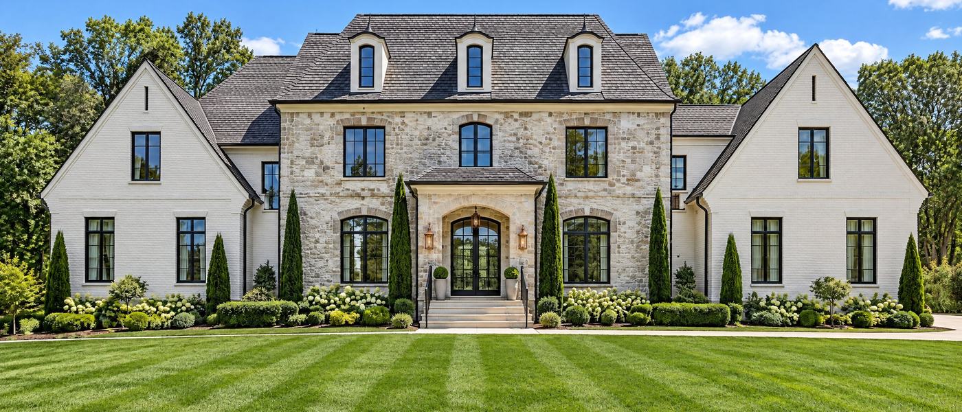 Concept rendering of a stone and white-brick estate home with a manicured lawn (illustrative only)